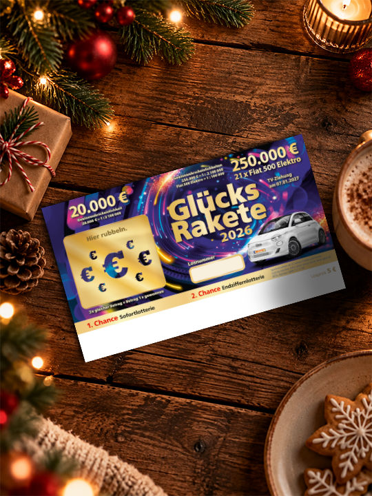 Gl&uuml;cksrakete-Los liegt auf einem weihnachtlich-dekorierten Tisch